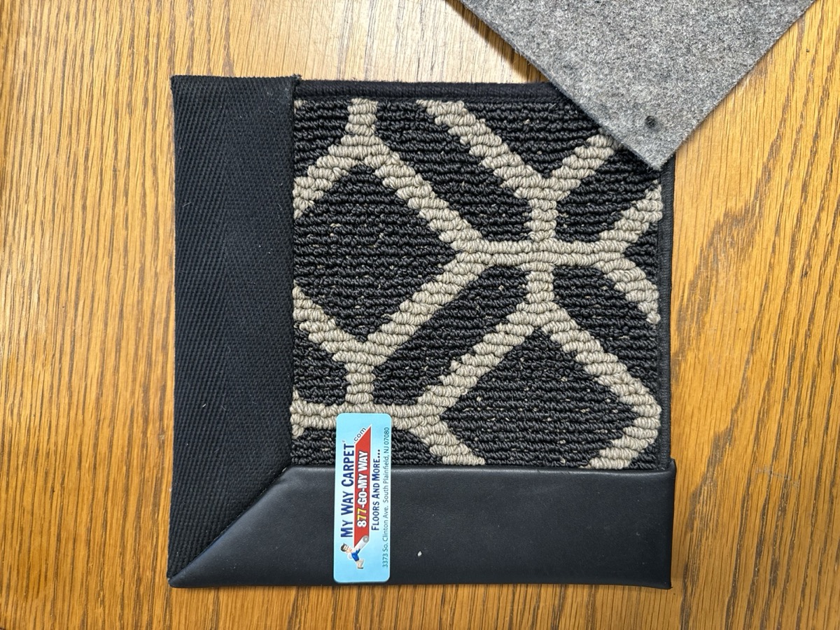 Carpet sample showing four different edge treatments on one piece