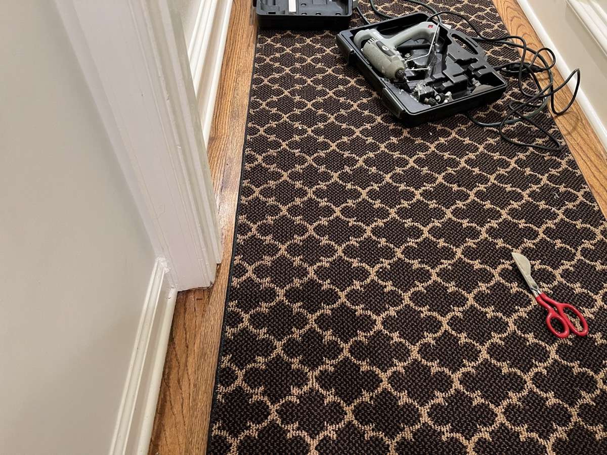 Finished hallway repair with invisible binding seam, ProGlide seam iron case beside it